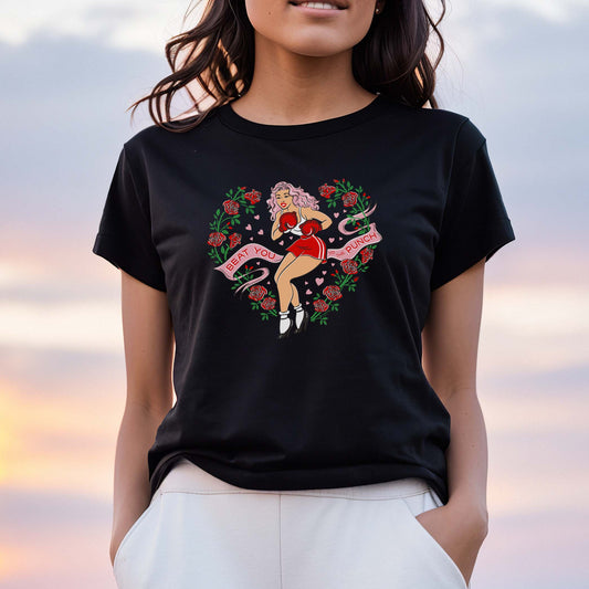 Person wearing a black t-shirt with a colorful design of a pinup lady wearing boxing gloves against a sunset sky.