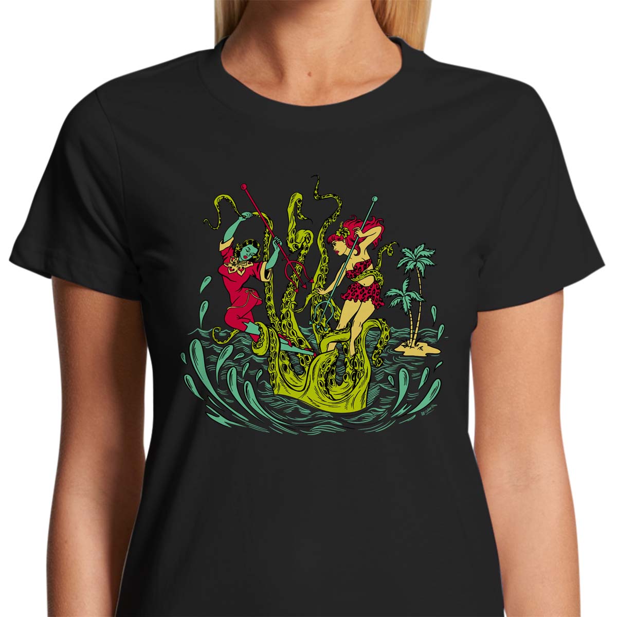 Ladies black t-shirt with a vintage tiki style graphic by 50s Vintage Dame showing two pinup women fighting a giant sea creature.