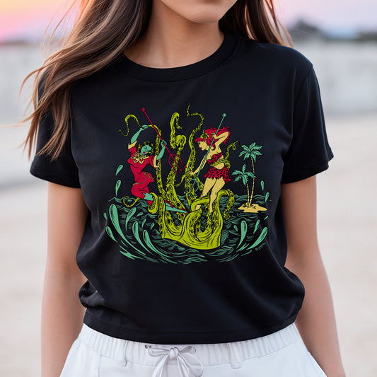 Ladies black t-shirt with a vintage tiki style graphic by 50s Vintage Dame showing two pinup women fighting a giant sea creature.