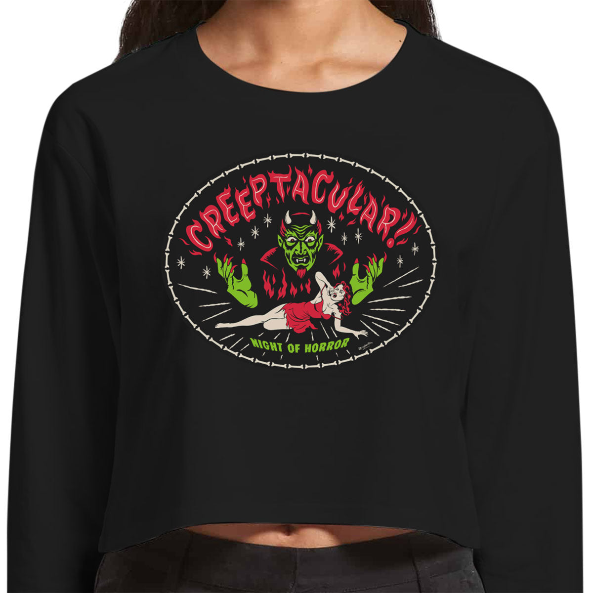 Creeptacular Black Long sleeved cropped ladies tee shirt  with a devil and a woman cowering in fear similar to a b-movie poster from the 1950s.