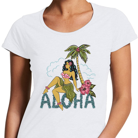 Ladies white scoop neck t-shirt with a pinup hula girl under a plam tree. Text made of flowers reads "ALOHA"