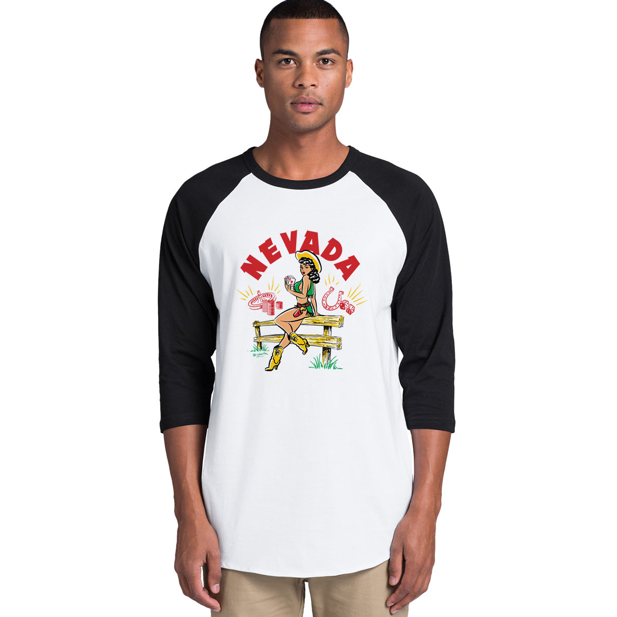 Vintage-style illustration by 50s Vintage Dame of a pinup cowgirl sitting on a wooden fence holding a Royal Flush. Headline says "Nevada" Raglan sleeve tee with white body and black sleeves.