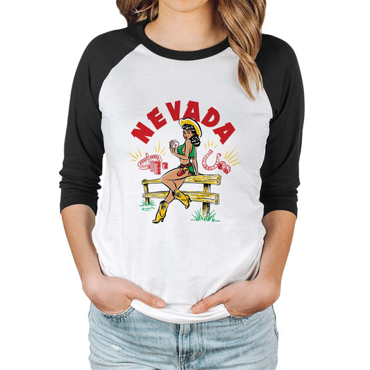 Vintage-style illustration by 50s Vintage Dame of a pinup cowgirl sitting on a wooden fence holding a Royal Flush. Headline says "Nevada" Raglan sleeve tee with white body and black sleeves.