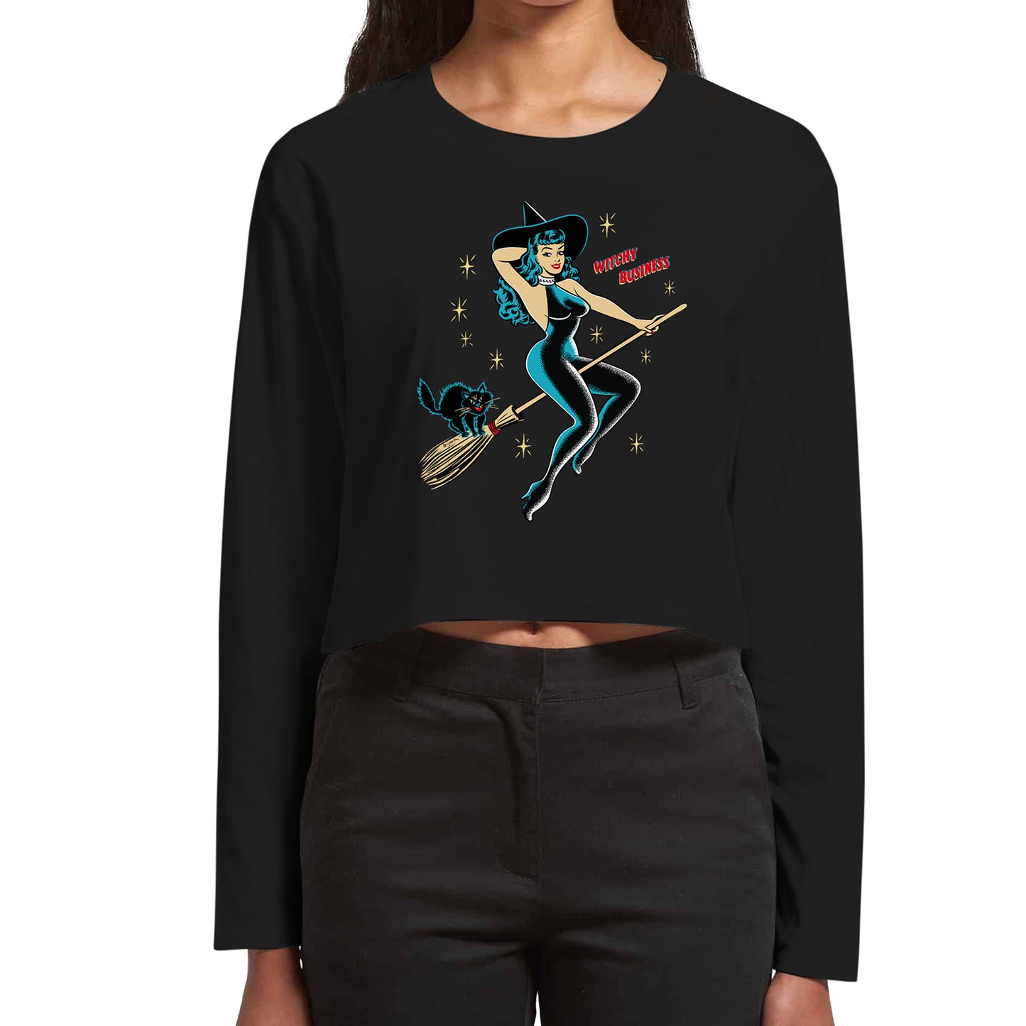 Halloween tee shirt. Vintage pinup witch riding a broomstick with a black cat on the back. Text reads "Witchy Business" Loadies long sleeved black cropped tee.