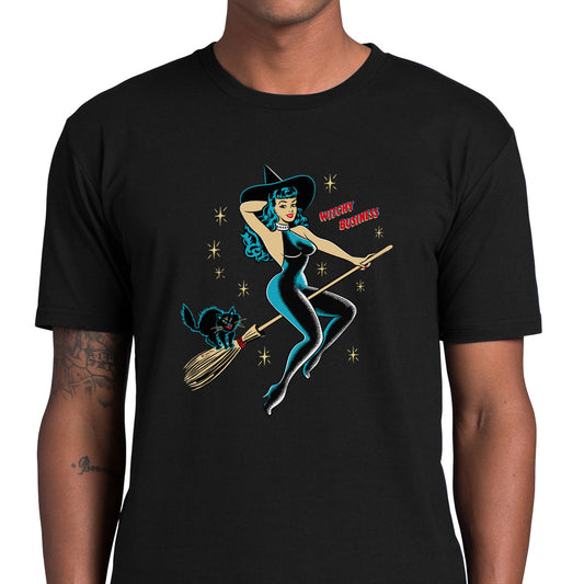 Unisex black Halloween tee shirt. Pictured on the front is a vintage pinup witch wearing a black catsuit riding a broomstick with a cat on the back. The text reads "Witchy Business"